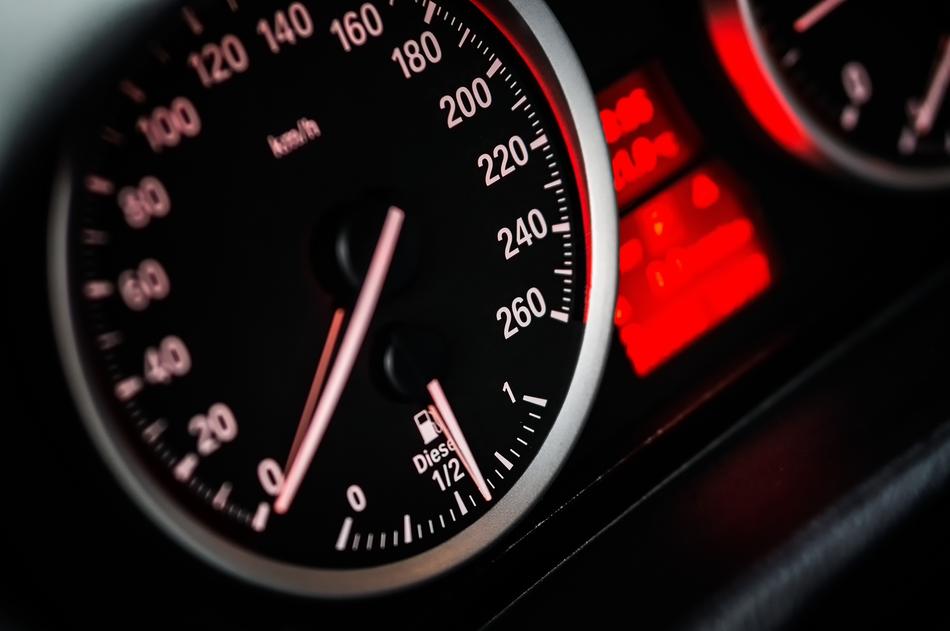 Red and white speedometer with arrows of the BMW car