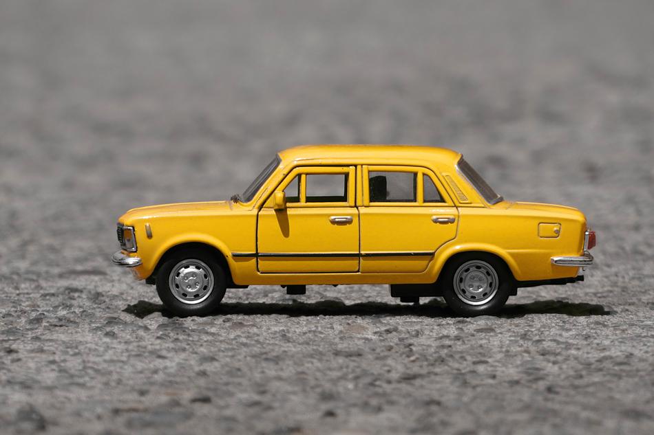 toy yellow car on the pavement