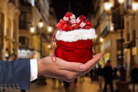 christmas bag with gifts in the palm