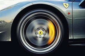 Alloy wheel of the beautiful Ferrari car, in movement