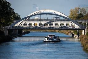 the boat sails under the bridge on the Mittelland Canal, Germany