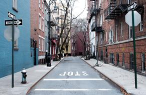 Beautiful landscape of the street, with the one way pavement, signs and colorful buildings