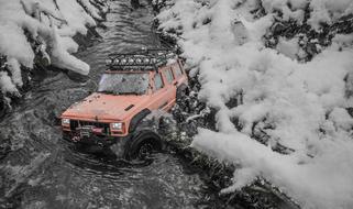 the jeep rides through the mud