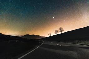 Beautiful colorful starry sky and empty road