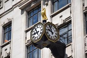 vintage clock on wall of historical building, uk, england, london