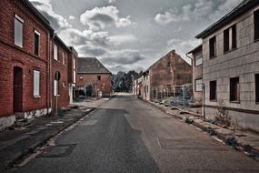 Beautiful road, among the buildings, under cloudy sky