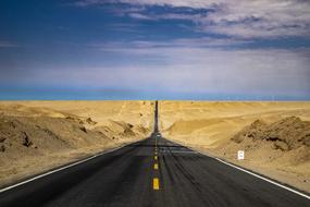 hills near an asphalt road