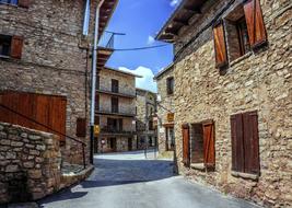 photo of old stone buildings on a narrow street in the city center