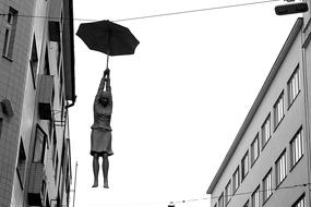 modern sculpture of a girl with an umbrella