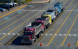 heavy Trucks in row on marked road