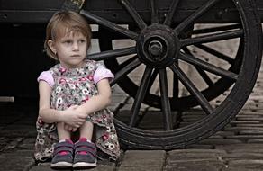 little girl sitting on ground