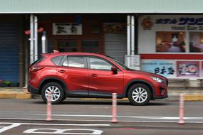 red mazda car on city street