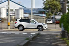 white jeep driving down the street