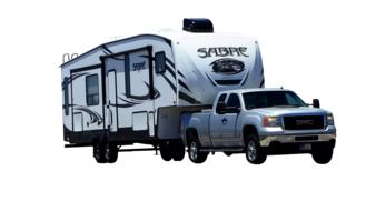 photo of a pickup truck carrying a camper van