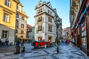 red retro car in the central square in Prague, Czech Republic
