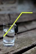 a glass of water with an ignition key