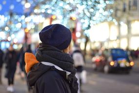 illuminated photo of people on city road in winter