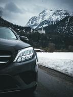 new Mercedes Benz car at scenic winter landscape, detail