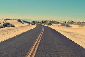 empty Road through sand dunes, usa, route 66