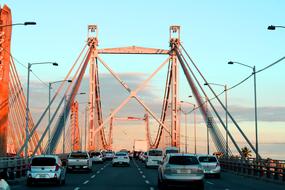 A lot of cars on the bridge, on the beautiful landscape, at colorful sunrise in the sky