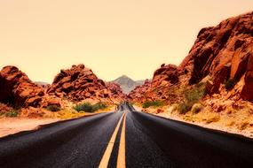 empty Road through scenic red rock formations, usa, Nevada