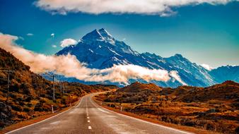 Beautiful and colorful landscape with the road on the mountains in clouds, in New Zealand