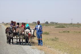 passengers on a teoege with a donkey, Africa