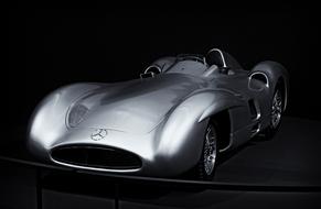 Grey shining classic racing car in the darkness
