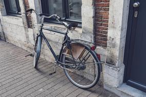 old bike parked near the wall