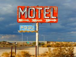 motel pool sign on road