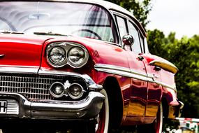 red classic car with chrome details