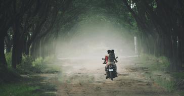 couple on the bike in fog