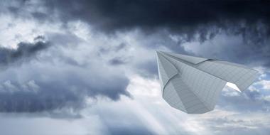 paper plane in the dramatic sky