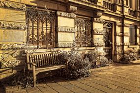 wooden bench by the building in the old style