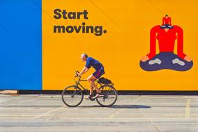 start moving, Cyclists at advertising wall