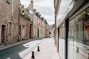 Beautiful landscape of the street with the houses in France, under the cloudy sky