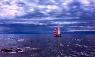 storm clouds over a sailboat in the ocean