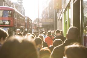 People, near the red double decker bus on the beautiful street in sunlight, in London, England, UK