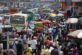 Crowd of people and heavy traffic on a street in Ghana, Africa