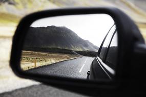 landscape reflection in the side mirror