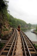 girl on rails among picturesque nature