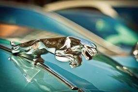 metal jaguar figurine on a car