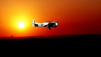 little aircraft on the orange sky