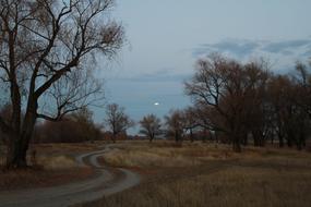 winding rural road in Russia against the evening sky