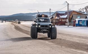 All terrain vehicle, on the beautiful, snowy landscape, near the Lake Baikal, among the mountains in Syberia