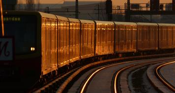 the sun shines on the suburban train cars