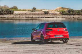 red volkswagen golf by the river