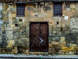 Beautiful and colorful, old, stone building with the wooden door in Nicosia on Cyprus, Greece