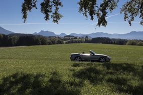 convertible mazda mx5 on a green field