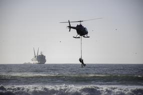 Rescuing a person, from the water, with the helicopter